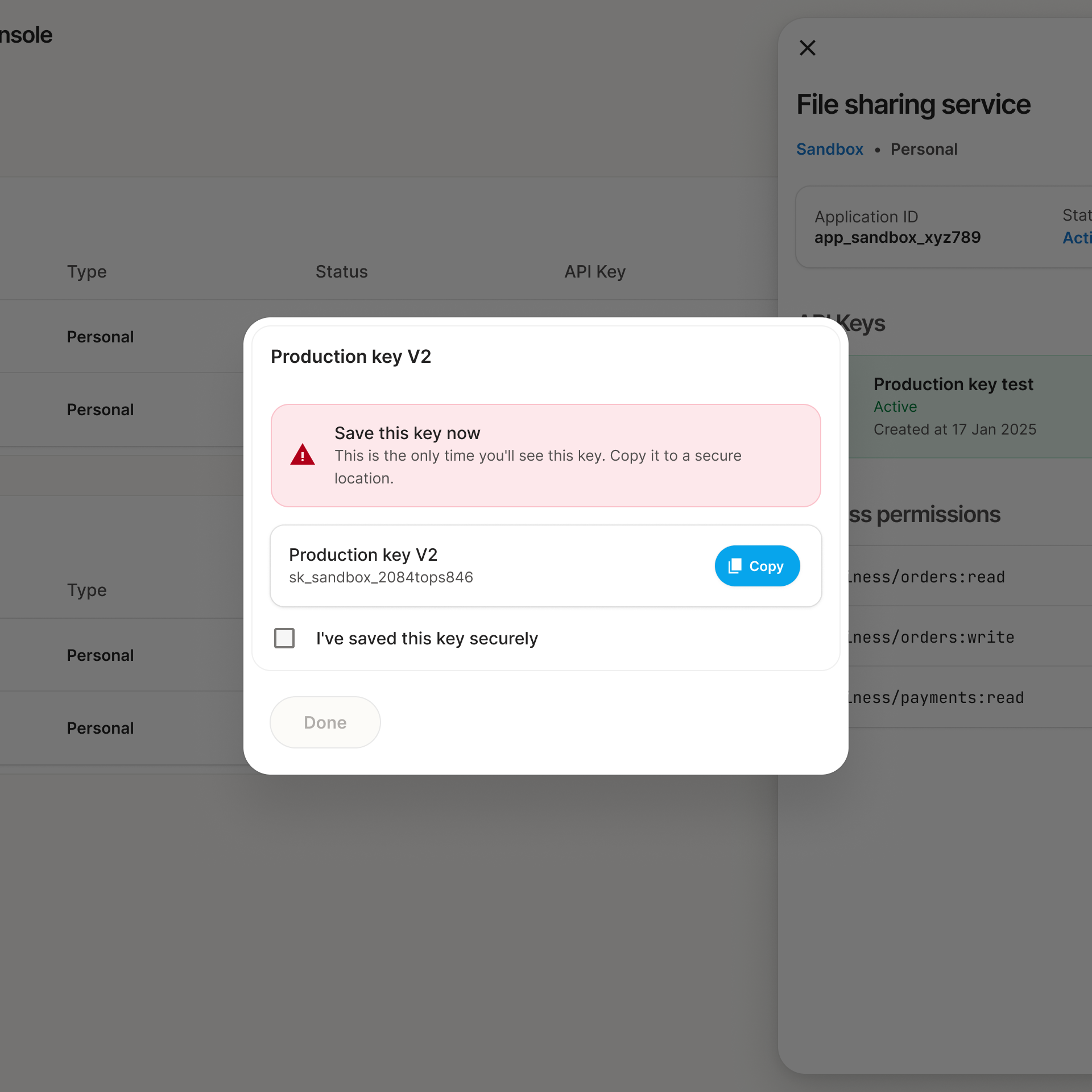 The one-time key dialog: a red warning that this is the only time the key will be shown, the key itself with a Copy button, and a checkbox confirming it has been saved.